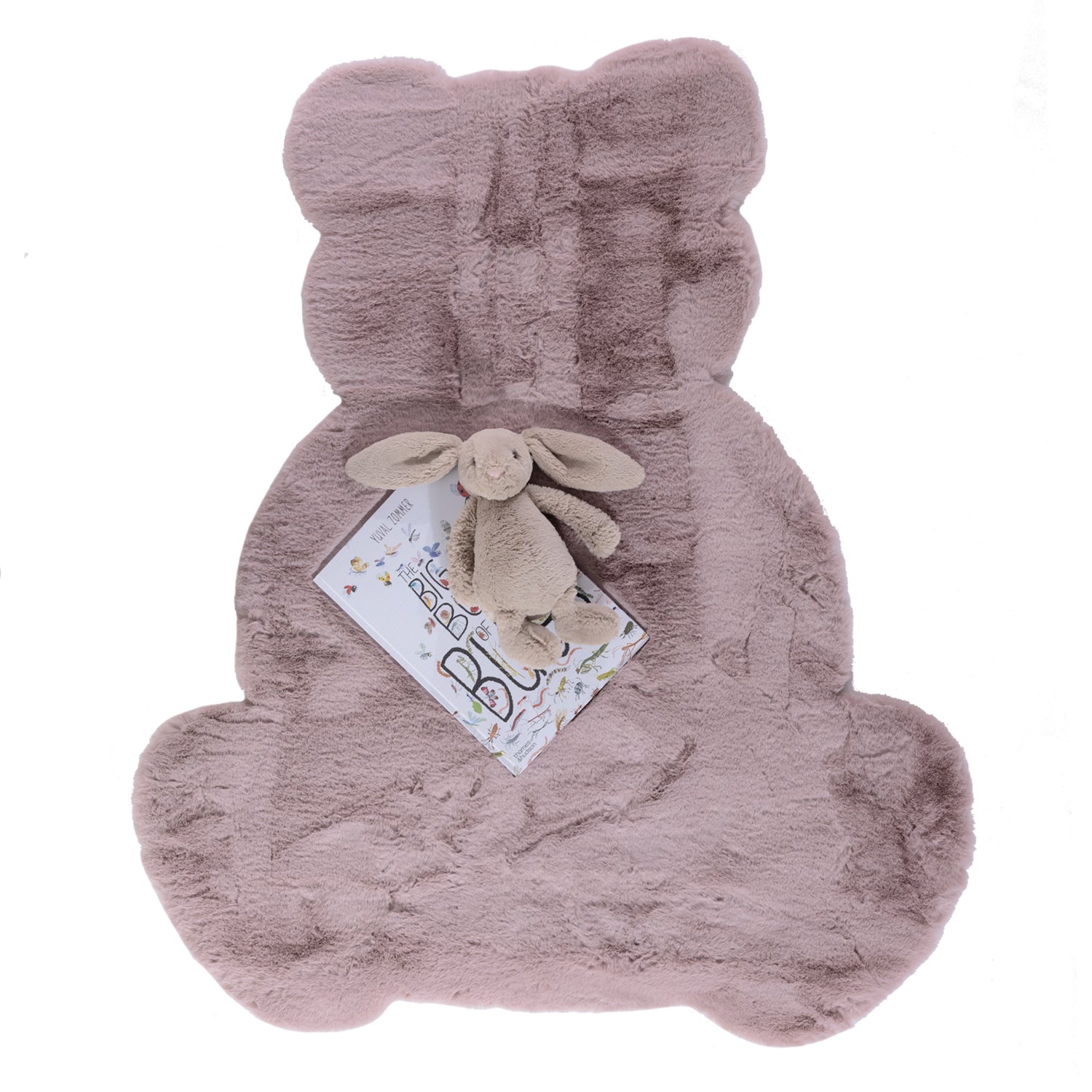 A plush blush pink faux fur rug in the shape of a seated teddy bear, featuring a luxuriously soft texture and a playful silhouette perfect for a nursery or children's bedroom.