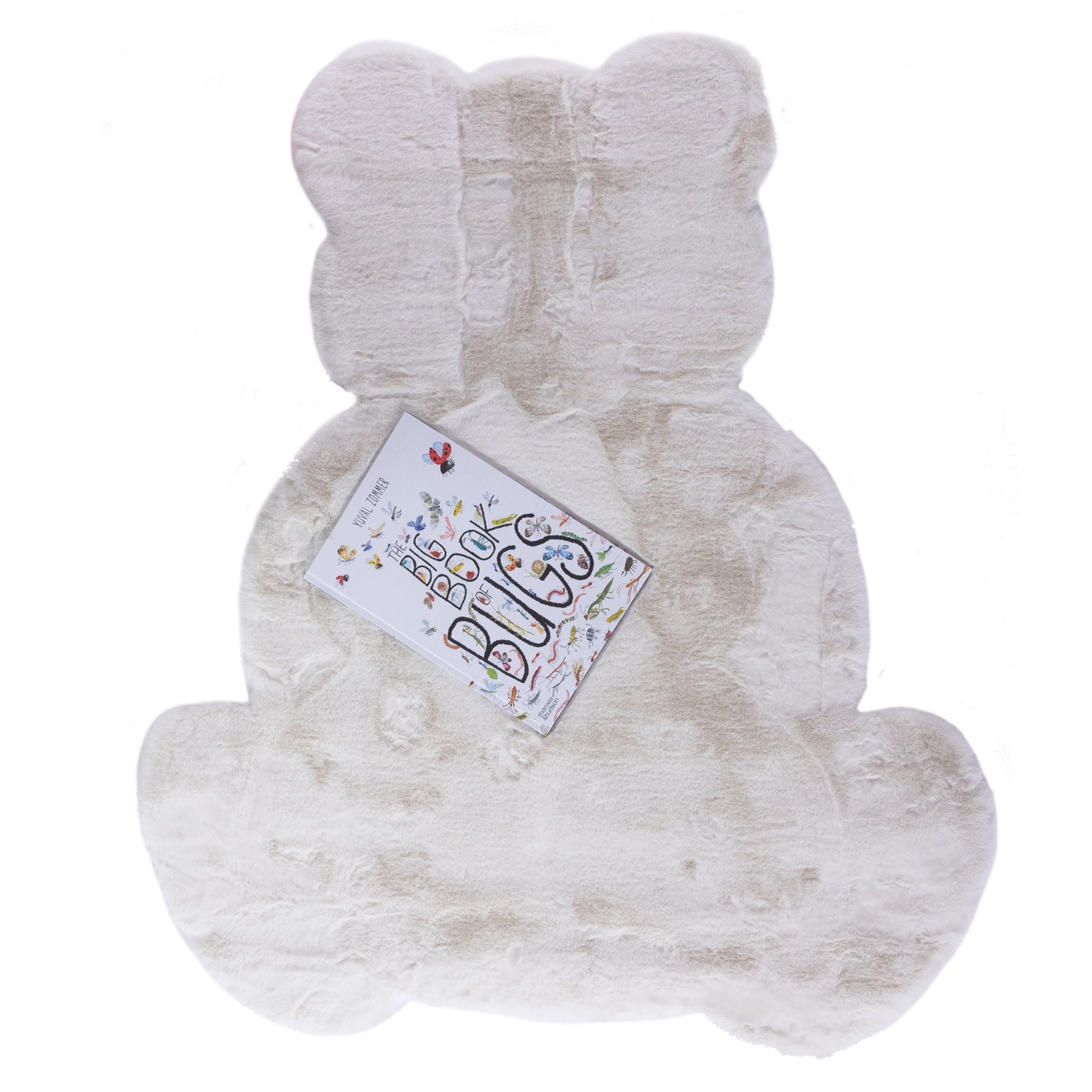 A plush ivory faux fur rug in the shape of a seated teddy bear, featuring a luxuriously soft texture and a playful silhouette perfect for a nursery or children's bedroom.