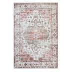 A rectangular vintage-style area rug with a distressed traditional pattern in soft pink, beige, and muted gray-brown tones, shown flat against a white background.