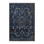 A rectangular vintage-style area rug with a distressed navy blue background and an intricate medallion pattern in muted beige, rust orange, and white, shown flat against a plain white background.
