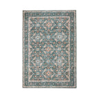 Design Republique Rihana Textured Rug in green, featuring an intricate vintage-inspired floral and geometric pattern in teal, cream and rust tones with a decorative border and distressed finish against a white background.