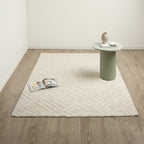 Brighton Rug 160 x 230cm in Natural, shown in a minimalist room with a soft cream finish and raised geometric diamond pattern.