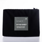Black fitted sheet with Solace branding on a white background