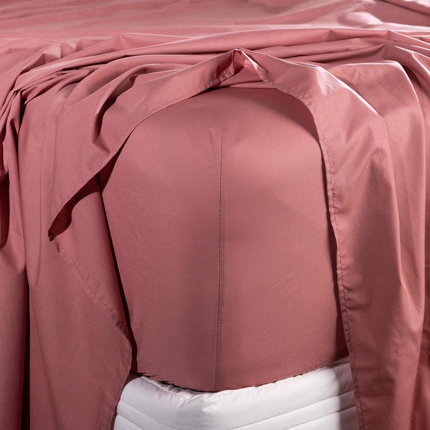 Close-up of pink bedding fitted sheet