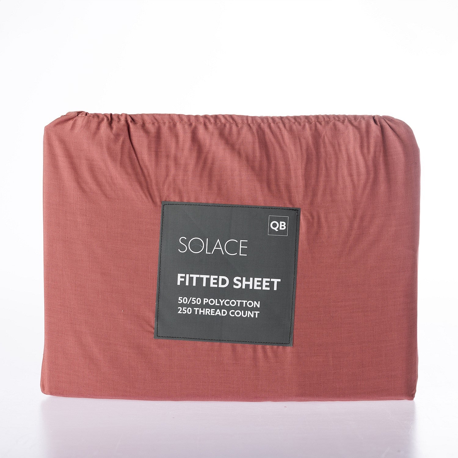 Red fitted sheet with a label on a white background