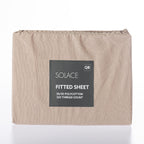 Beige fitted sheet with a label on a white background
