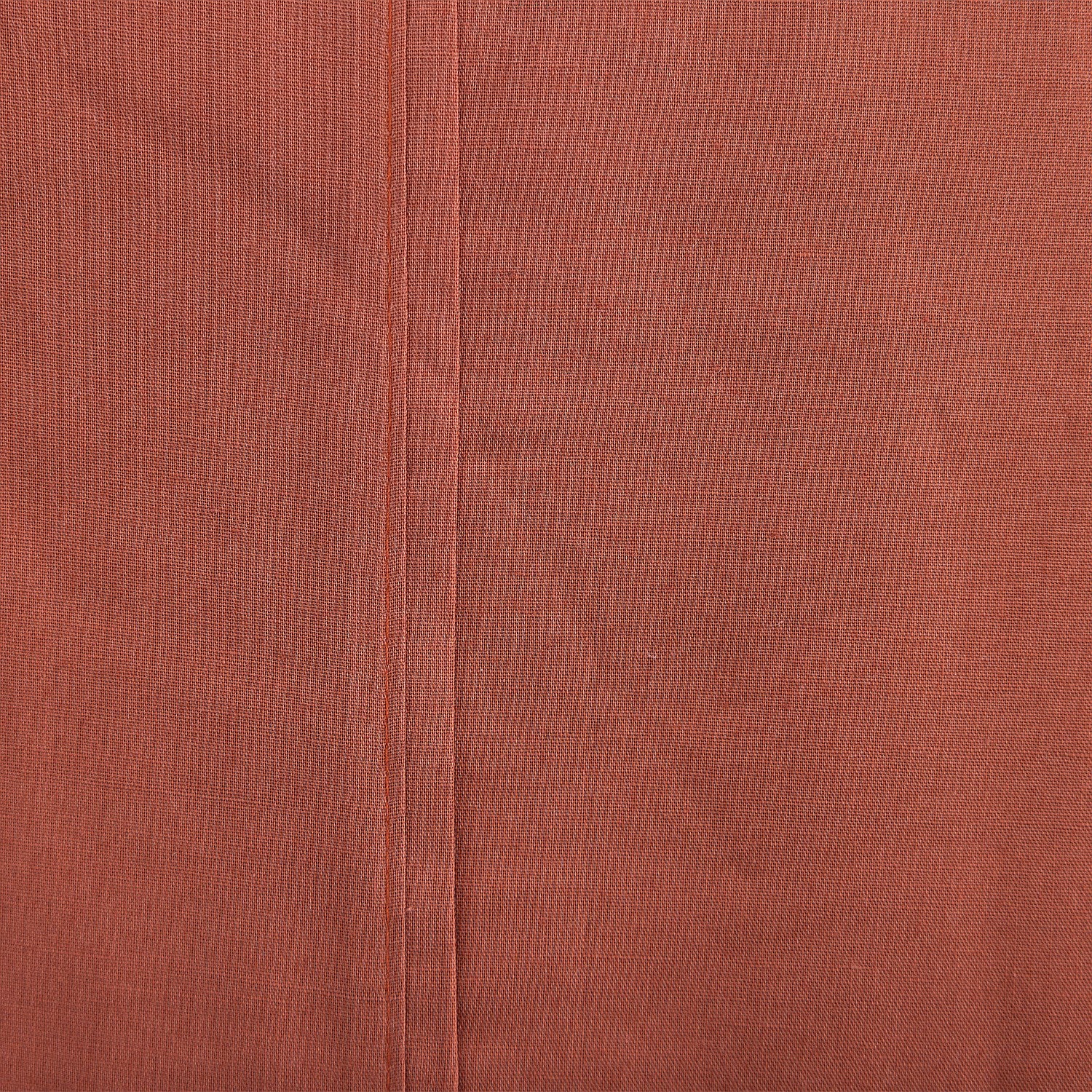 Close-up of a brown fabric surface with a seam
