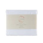 White linen flat sheet with a visible brand label on a white background