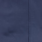 Close-up of smooth blue cotton sheet fabric with stitched hem detail.