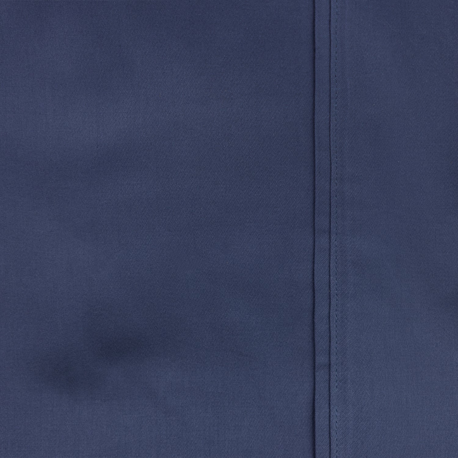 Close-up of smooth blue cotton sheet fabric with stitched hem detail.