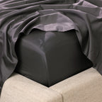 A close-up of a fitted sheet wrapped smoothly around the mattress highlights its crisp finish, tailored fit and luxurious sateen-like appearance.