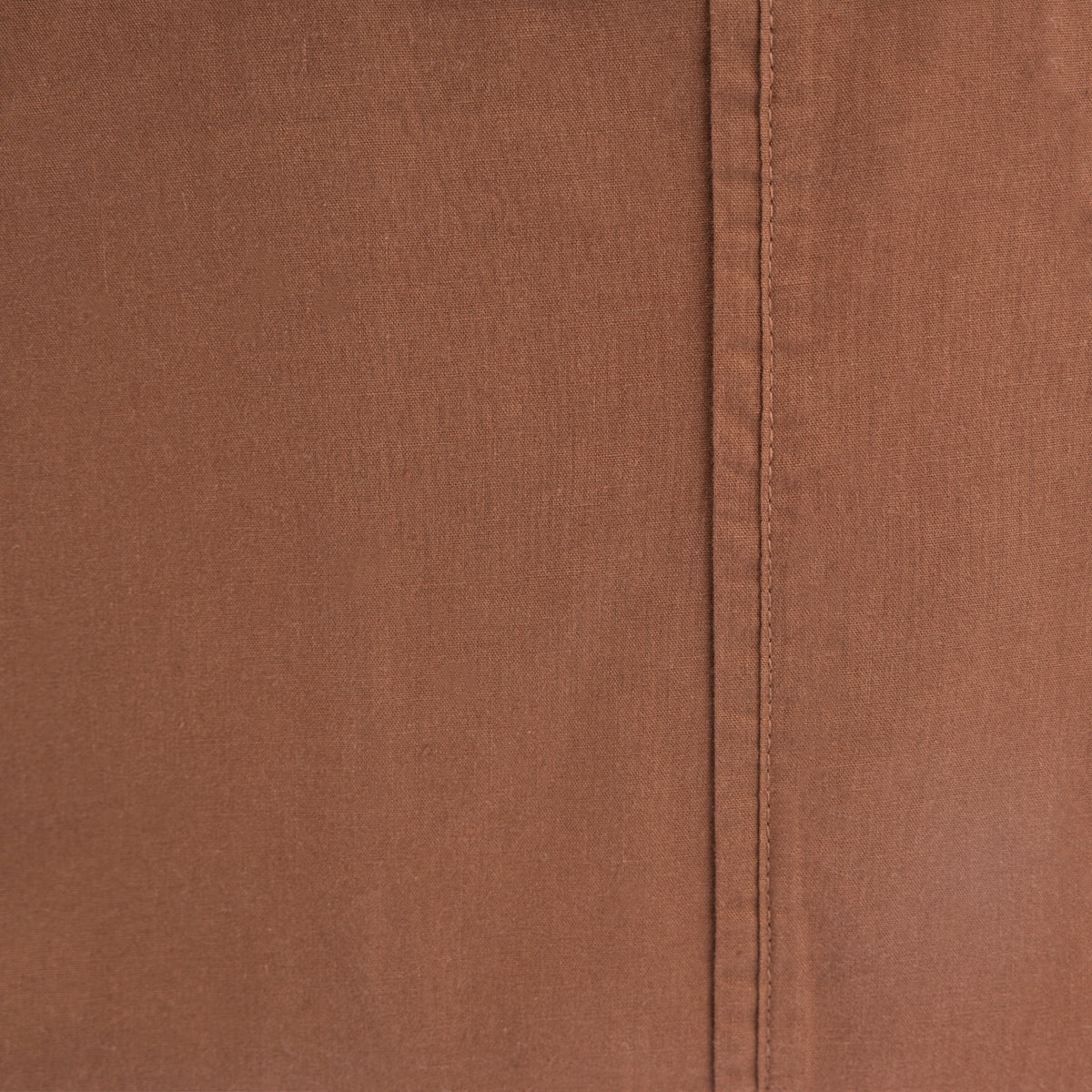 Design Republique Quinn 100% Cotton Washed Sheet Set in Rust, styled on a bed with matching fitted and flat sheets and pillowcases.