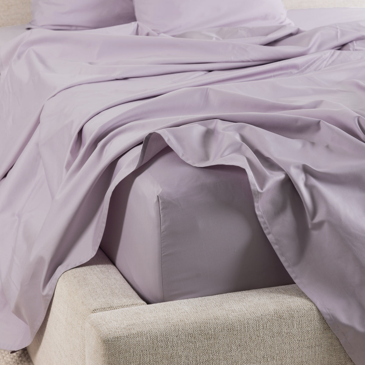 A close-up of the Gracious Living Avery Sheet Set in Dusky Mauve, featuring smooth cotton sateen sheets draped across a bed with matching pillowcases and a fitted sheet.
