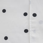 Close-up of the Pure & Simple Monroe Sheet Set in white and black, showing the black polka dot pattern and stitched seam detail.