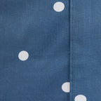 Close-up of the Pure & Simple Monroe Sheet Set in navy, showing the white polka dot pattern and stitched seam detail.