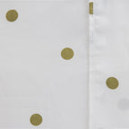 Close-up of the Pure & Simple Monroe Sheet Set in white and olive, showing the olive polka dot pattern and stitched seam detail.