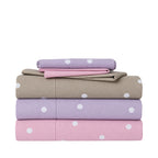 Stacked Pure & Simple Monroe Sheet Sets in blush, lilac and mocha, featuring a white polka dot design with coordinating plain pillowcases folded on top.