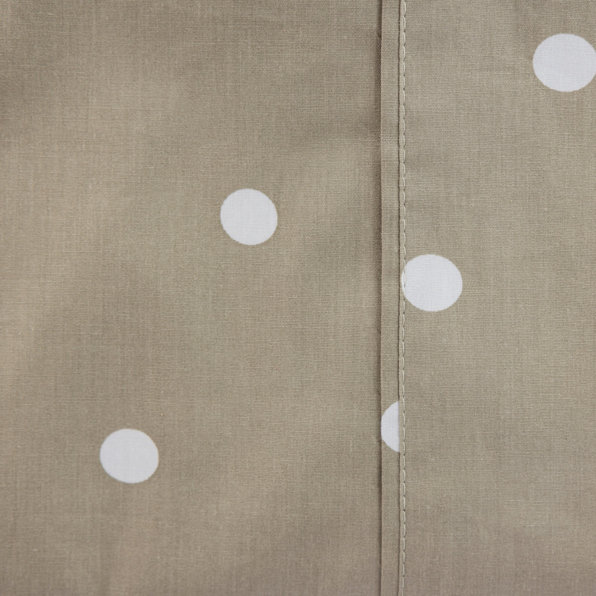 Close-up of the mocha Monroe Sheet Set showing the neutral brown fabric, white polka dot print and stitched seam detail.