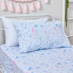 Close-up of the Mermaid Dreams fitted sheet and pillowcase showing mermaids, dolphins, octopus, jellyfish, shells and other ocean motifs in soft pastel colours.
