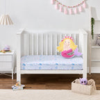 Mermaid Dreams fitted sheet styled on a white toddler bed with a decorative mermaid cushion and pastel bedroom accessories.
