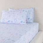 Mermaid Dreams fitted sheet set displayed with coordinating pillowcases, showing the detailed pastel underwater print.