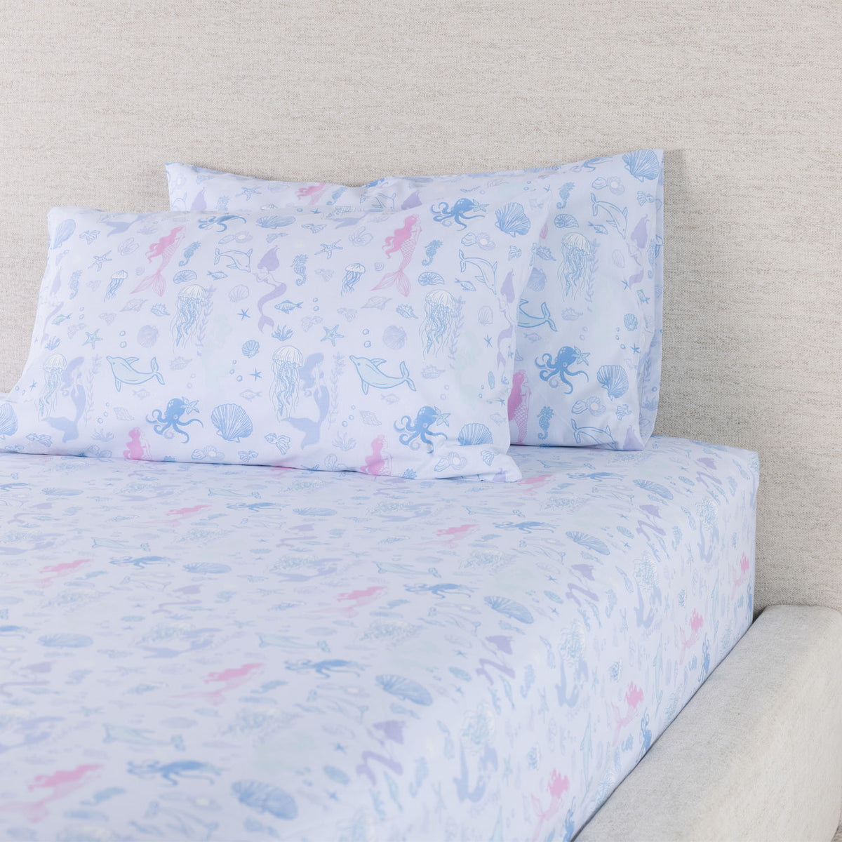 Mermaid Dreams fitted sheet set displayed with coordinating pillowcases, showing the detailed pastel underwater print.
