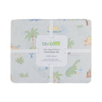 bb&b Kids Dino Beach Party fitted sheet set folded and packaged, featuring a pale blue dinosaur beach print with palm trees, sandcastles and beach accessories.