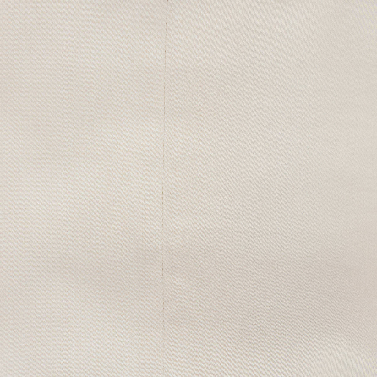 A close-up of a almond textured fabric with a subtle vertical seam.
