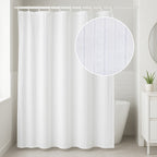 White satin stripe shower curtain hanging in a modern bathroom with a white bathtub.