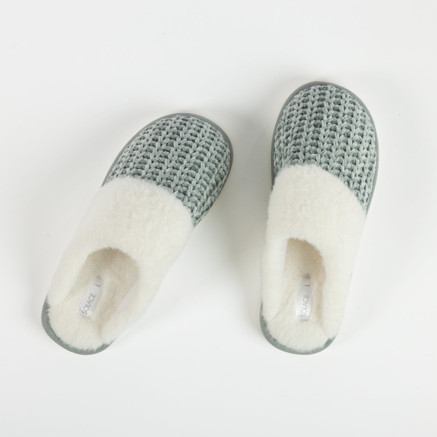 A pair of sea mist chenille slippers with plush white faux fur lining are displayed on a clean white background, highlighting their soft texture and cosy design.