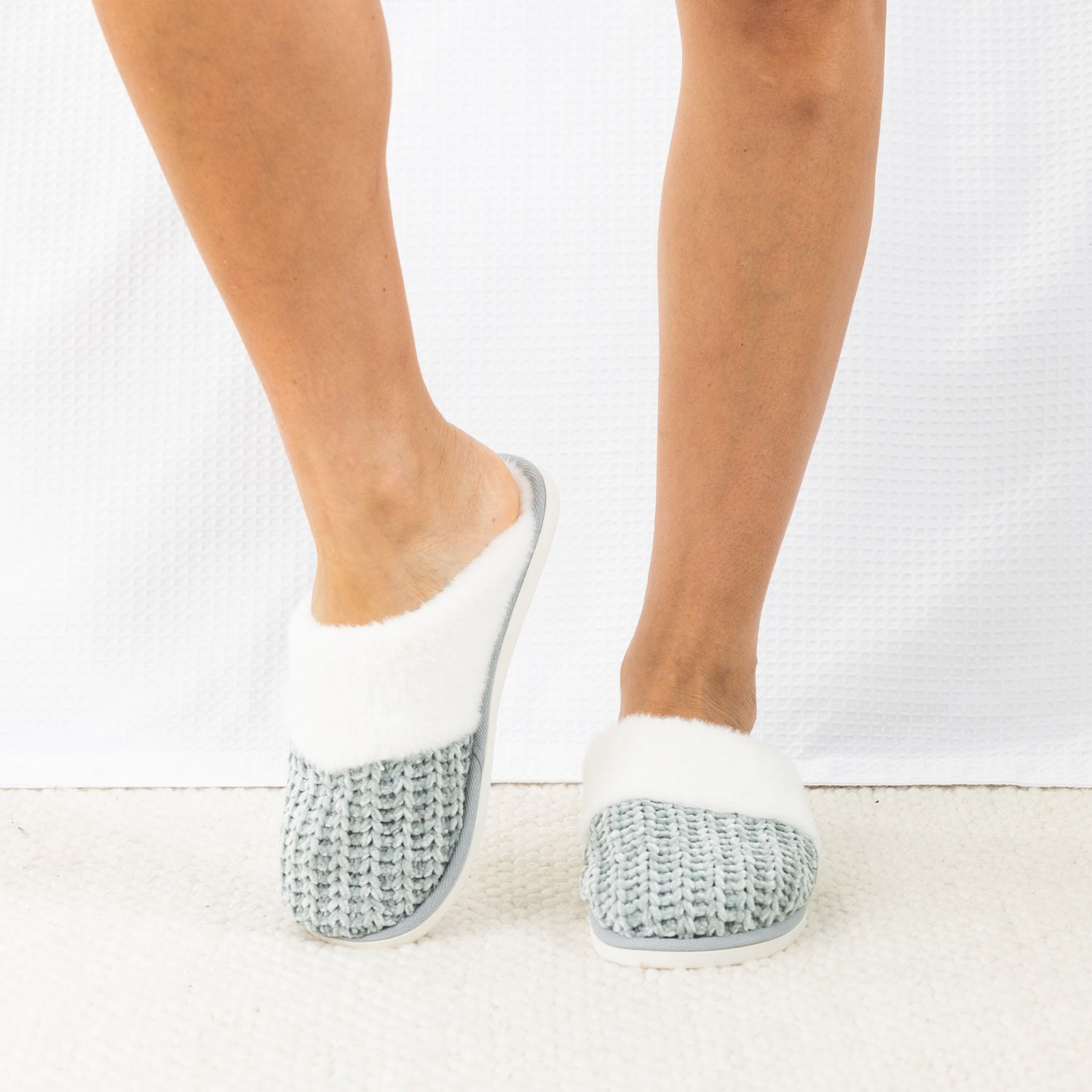 Person wearing Solace Chenille Faux Fur Trim Slippers in Sea Mist, featuring a soft chenille upper with plush white faux fur trim.
