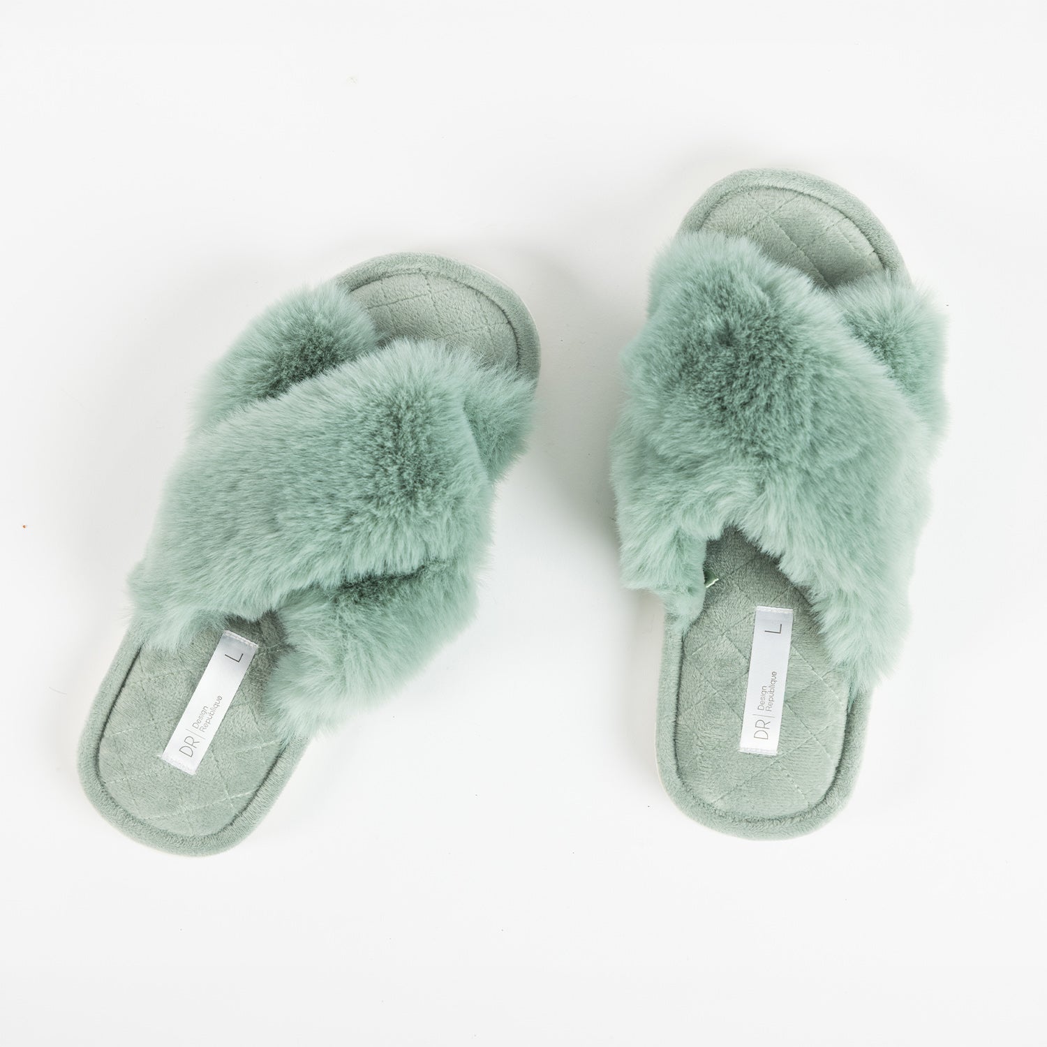 Pair of Design Republique Katie crossover slippers in Sage, featuring a plush faux fur crossover upper and a soft quilted footbed, shown from a top-down view.