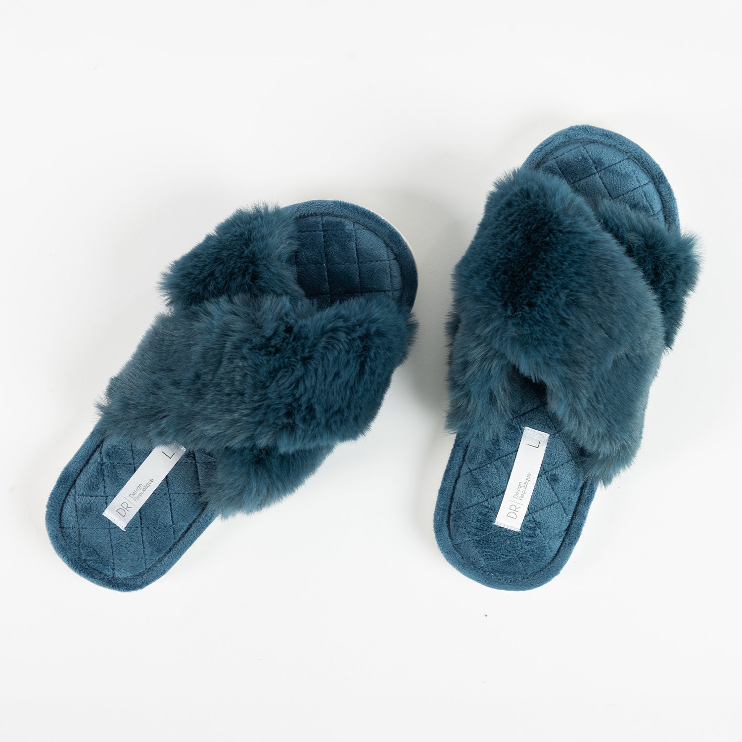 Pair of Design Republique Katie crossover slippers in Teal, featuring a plush faux fur crossover upper and a soft quilted footbed, shown from a top-down view.