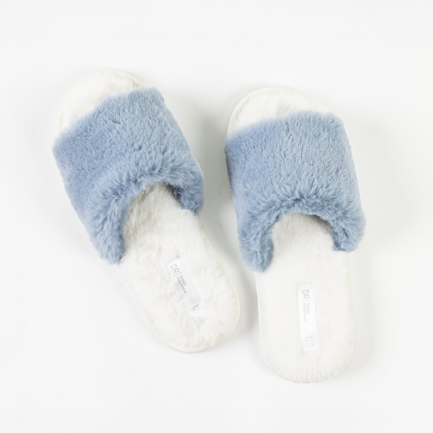 A pair of fluffy light blue faux fur slippers with soft white footbeds is displayed from above, showcasing their plush texture and cosy open-toe design.
