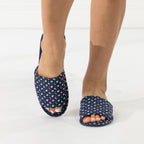 Navy floral open-toe slippers shown being worn from the front.