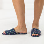Navy floral open-toe slippers shown being worn from the front and side.