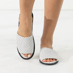 Solace Gracie Quilted Slippers White featuring a black polka dot print, shown worn from an angled view.