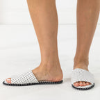 Solace Gracie Quilted Slippers White featuring a black polka dot print, shown worn from the side and front.