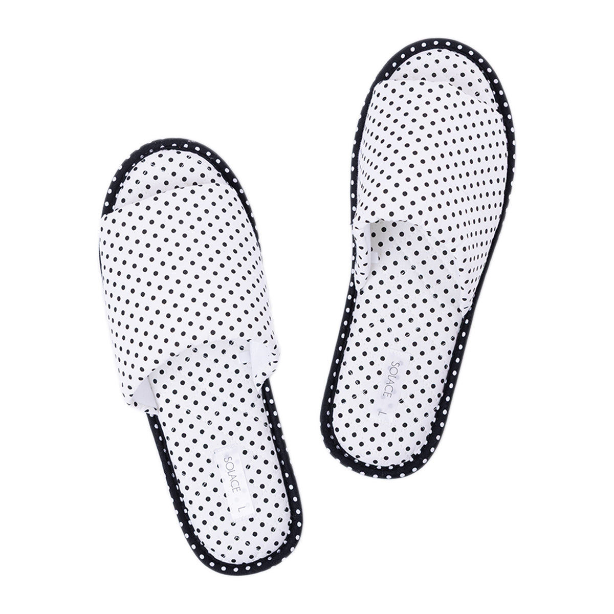 Pair of Solace Gracie Quilted Slippers White featuring an all-over black polka dot print and contrasting black trim.