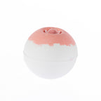 Round white bath fizzer with a soft pink top and a decorative rose-shaped centre, scented in Rose.