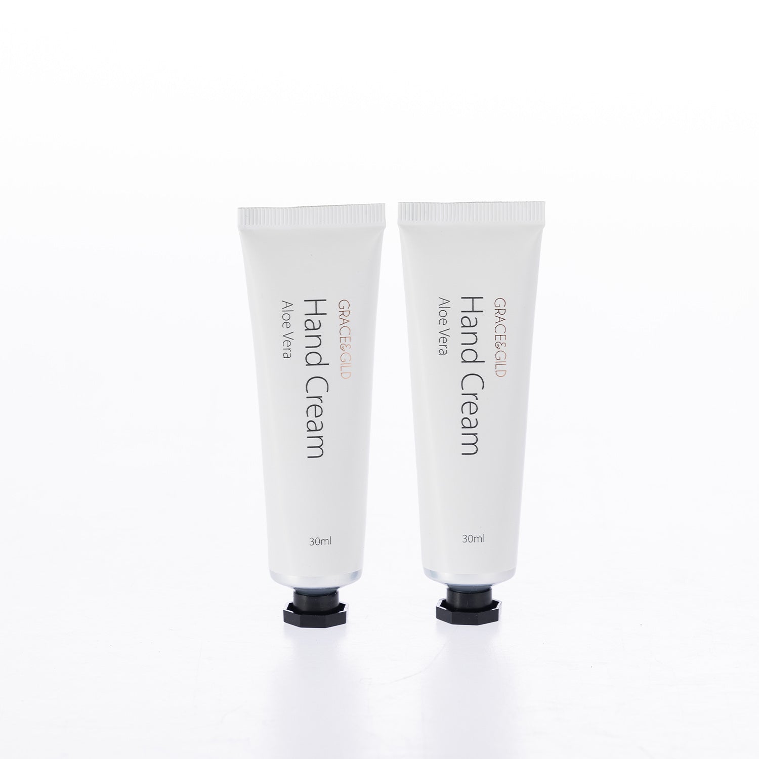 Two Grace & Gild Aloe Vera Hand Cream 30ml tubes with white packaging and black caps displayed side by side.