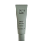 Smith & Co. Amber & Freesia Hand & Nail Pomade 80ml in a sage green tube against a white background.