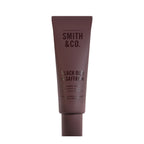 Smith & Co. Black Oud & Saffron Hand & Nail Pomade 80ml in a burgundy tube against a white background.