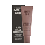 Smith & Co. Blush Rose & Blackberry Hand & Nail Pomade 80ml in a dusty pink tube displayed alongside its black packaging against a white background.