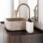 Two Smith & Co. Tonka & White Musk white pump bottles positioned beside a natural stone basin on a dark timber bathroom vanity.