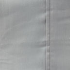 Grey sheet laid out up close.