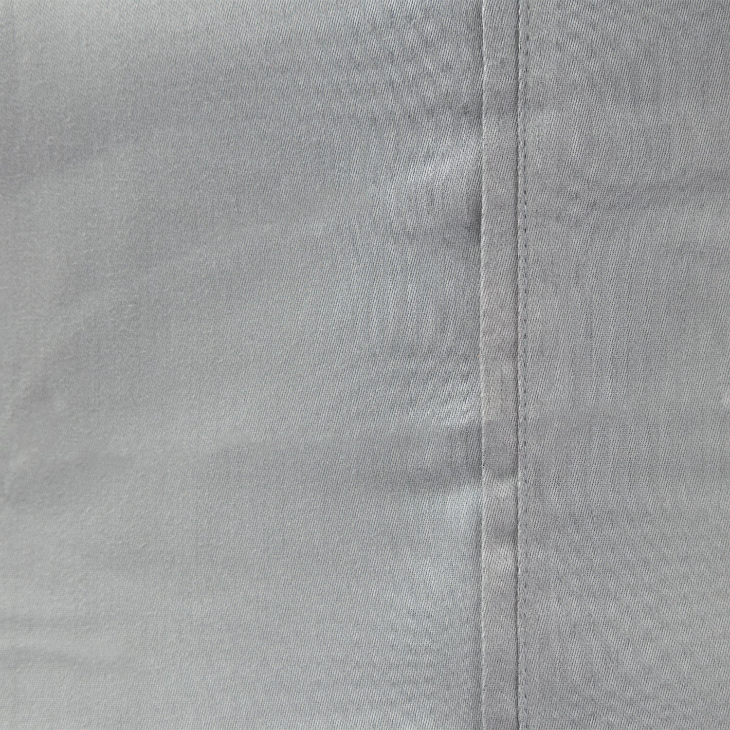 Grey sheet laid out up close.