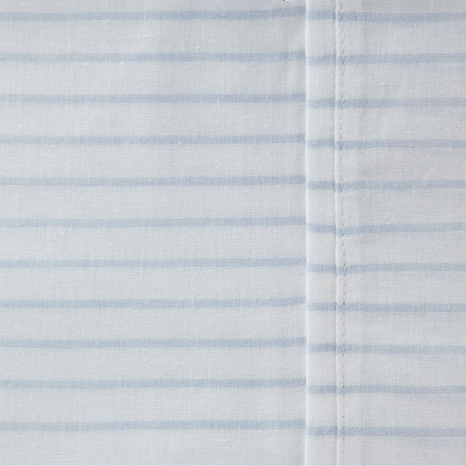 Close-up of the Pure & Simple Sutton blue sheet set featuring fine blue horizontal stripes on white cotton fabric.