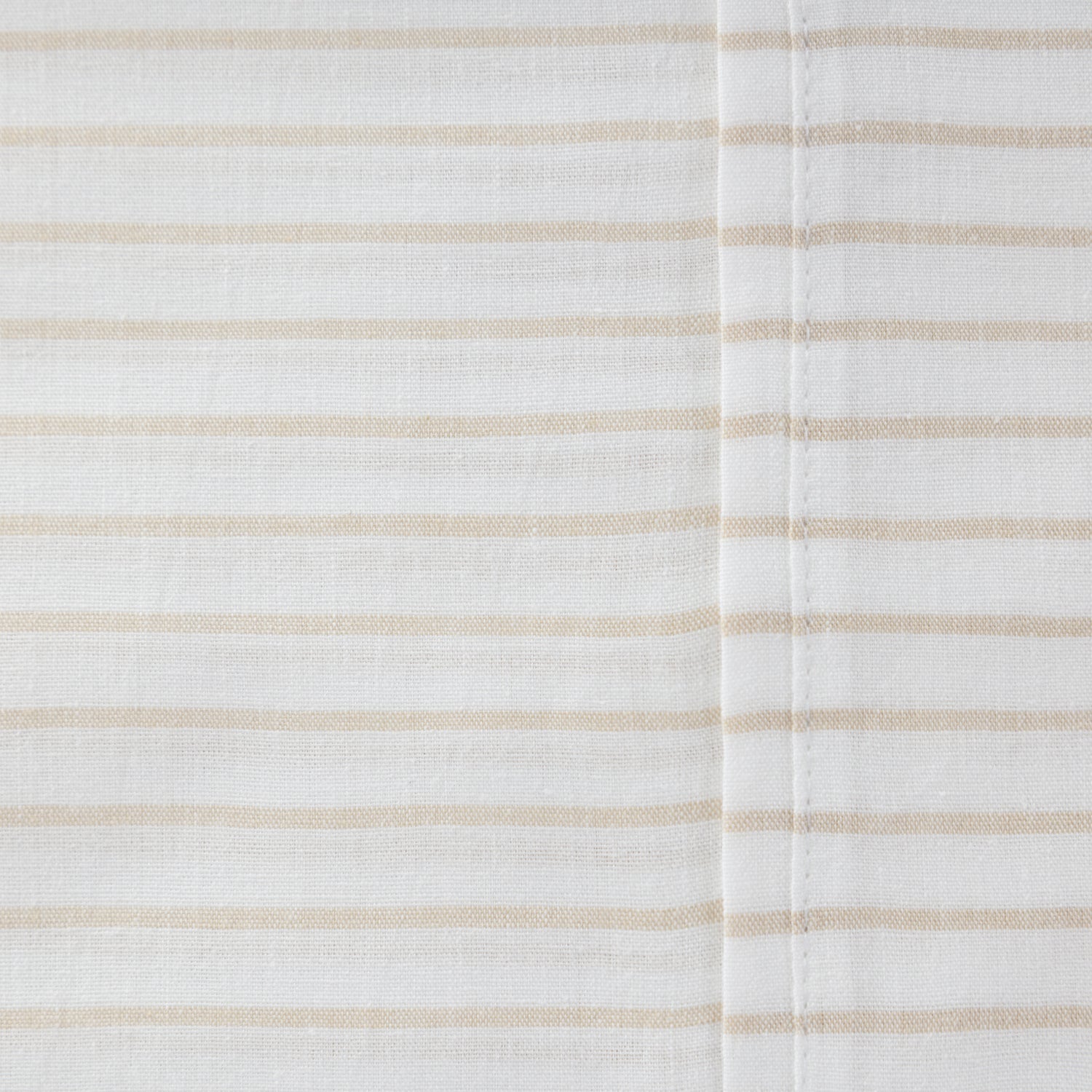 Close-up of the Pure & Simple Sutton natural sheet set featuring fine beige horizontal stripes on white cotton fabric.