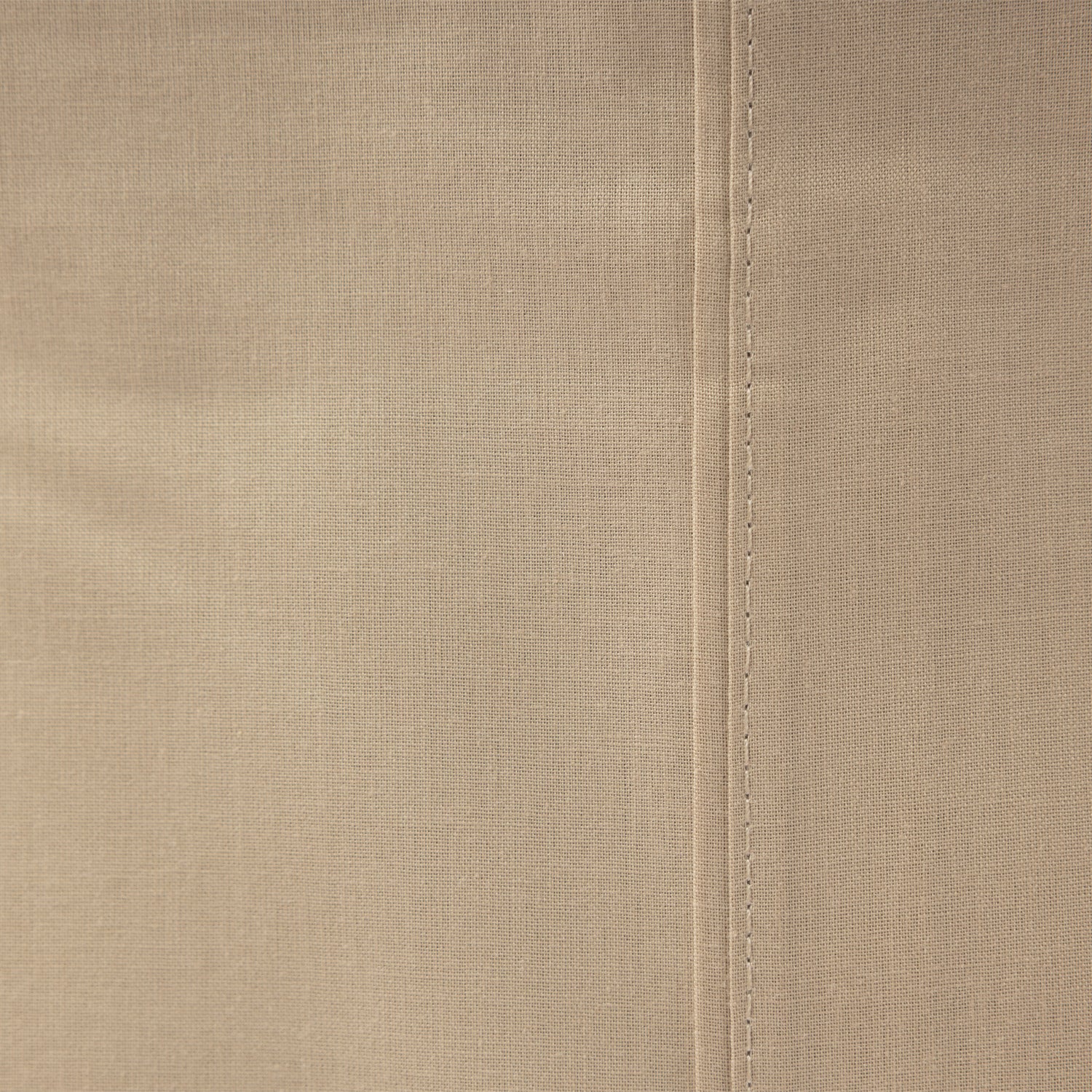 Close-up of the Home Co. Ella Cotton Sheet Set in Stone, showing the neutral beige tone, woven cotton texture and stitching.